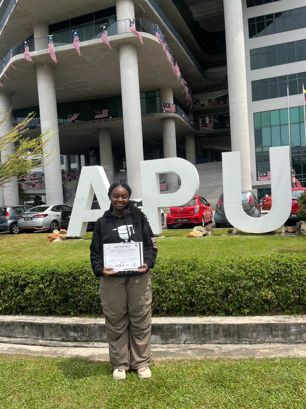 Malaika โ Wordly Admissions student at Asia Pacific University (APU), Malaysia, with her approval certificate