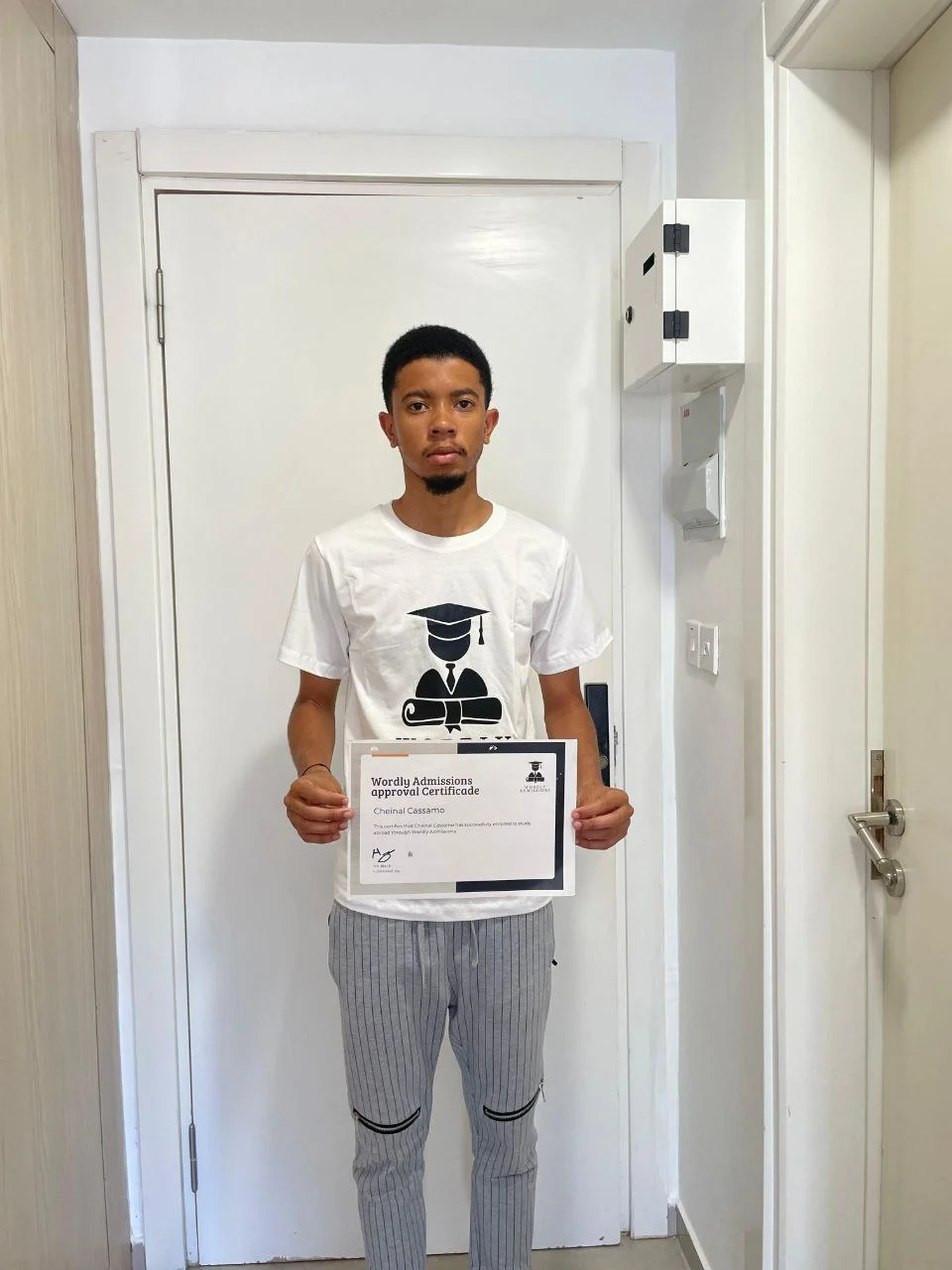 Wordly Admissions student Cheinal Cassamo holding his approval certificate